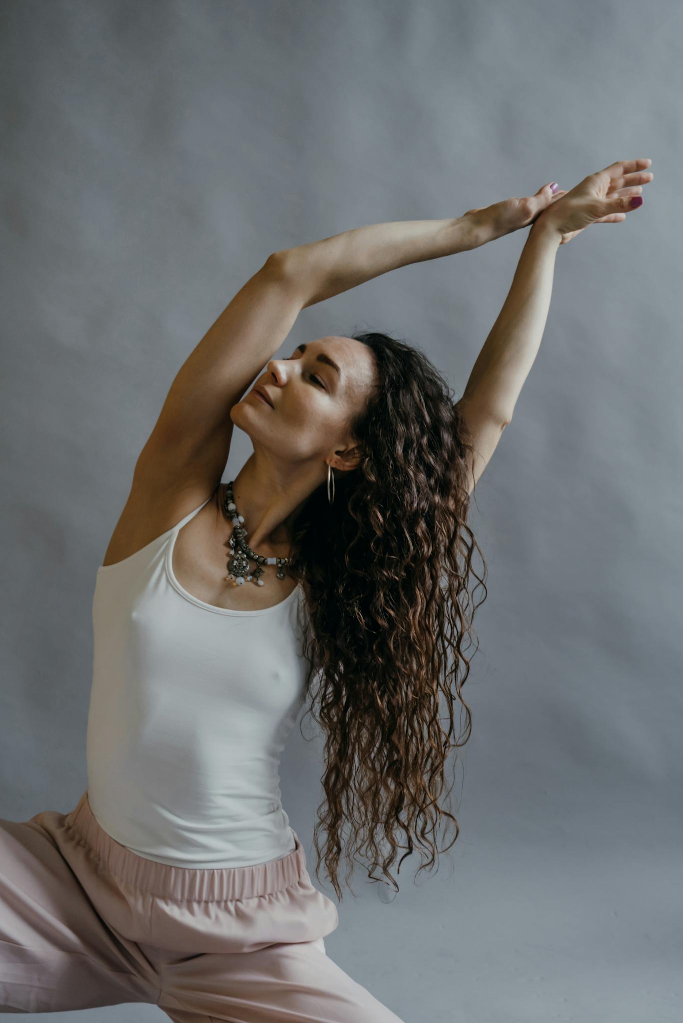 A serene moment of a woman practicing a yoga pose indoors, focusing on relaxation and mindfulness.