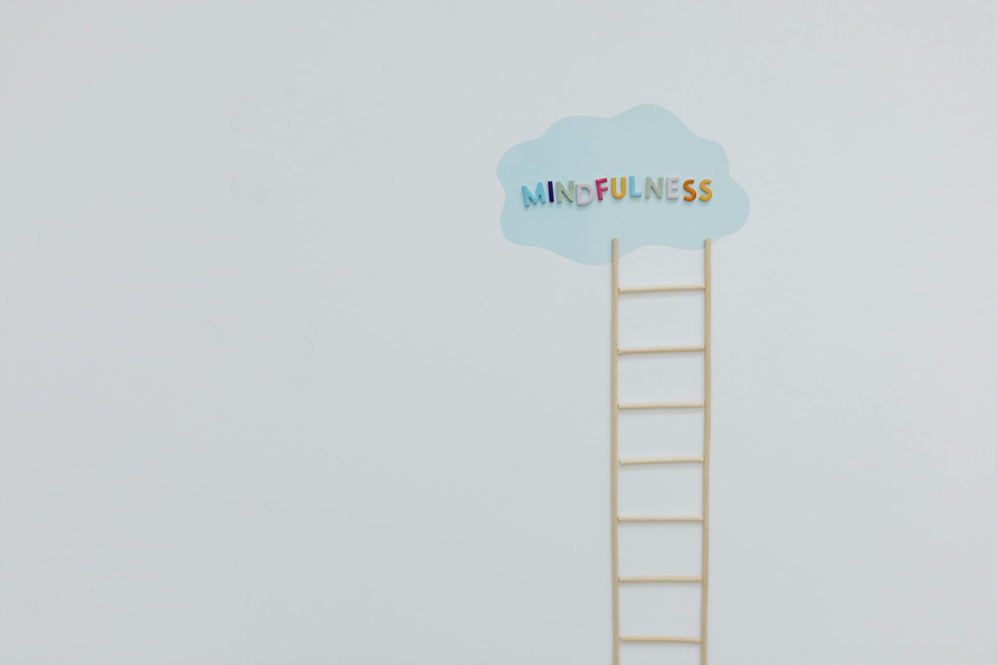 Creative mindfulness concept with a ladder and cloud on a minimalist white backdrop.